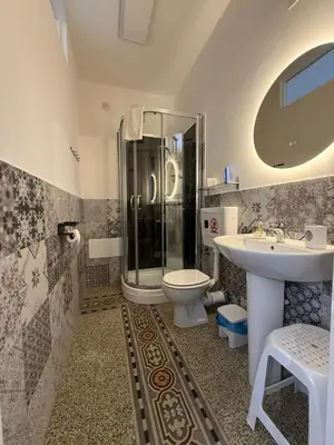 a bathroom with a shower and a toilet and a sink at GUEST HOUSE BOSCO in Palermo