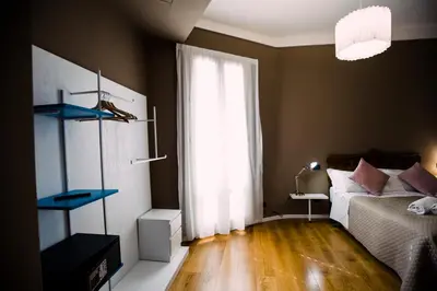 a bedroom with a bed and a large window at Villa Calipso in Mondello