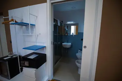 a small bathroom with a toilet and a sink at Villa Calipso in Mondello
