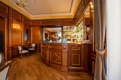 a bar in a room with wooden walls and wooden floors at Grand Hotel Wagner in Palermo