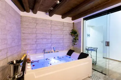 a bath tub in the corner of a room at Principe di villafranca Suite in Palermo