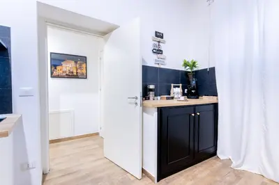 a bathroom with a black cabinet in a white room at Principe di villafranca Suite in Palermo