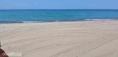 a sandy beach with the ocean in the background at Stella marina in Buonfornello