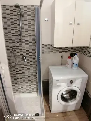 a bathroom with a washing machine and a shower at Stella marina in Buonfornello