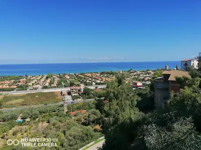 a view of a town with the ocean in the background at Stella marina in Buonfornello