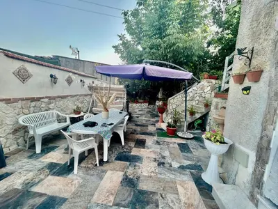 a patio with a table and a purple umbrella at Aromi di Sicilia Casa Vacanze in Palermo