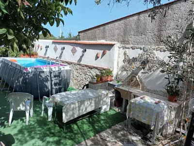 a patio with a table and chairs and a pool at Aromi di Sicilia Casa Vacanze in Palermo