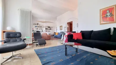a living room with a table and chairs at Molo Santa Lucia 248 in Palermo
