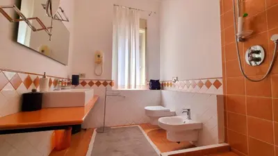a kitchen and a living room with a table at Molo Santa Lucia 248 in Palermo
