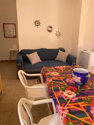 a living room with a table and a couch at Like Home Calamazzo di Sciacca in Scopello