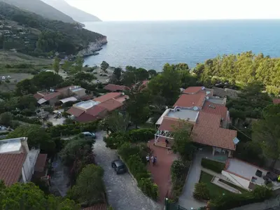 an aerial view of a house next to the ocean at Like Home Calamazzo di Sciacca in Scopello