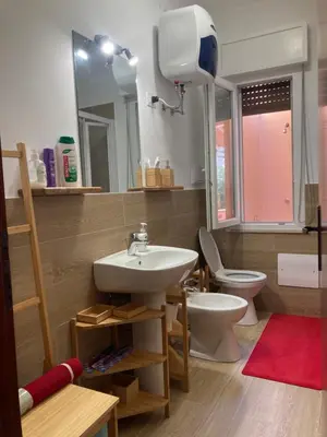 a bathroom with a sink and a toilet and a mirror at Like Home Calamazzo di Sciacca in Scopello