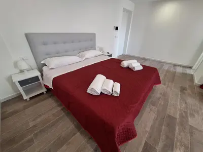 a bedroom with a bed with two towels on it at Domus Levante in Terrasini