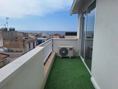 a balcony with green grass on a building at Domus Levante in Terrasini