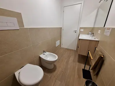 a bathroom with a toilet and a sink at Domus Levante in Terrasini