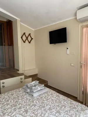 a bedroom with a bed with towels on it at Chirone Room in Mondello