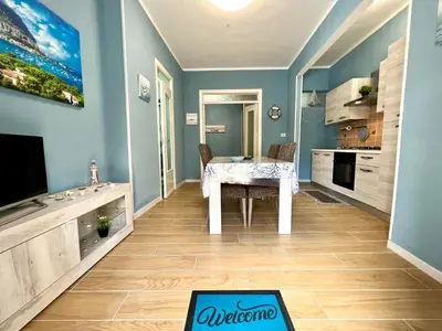 a kitchen with a dining room table and a tv at Casa del Pescatore in Isola delle Femmine