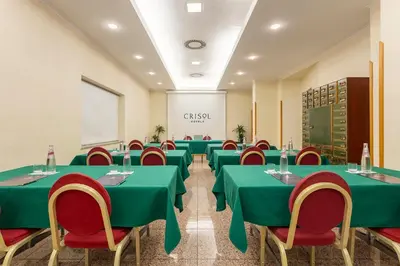 a conference room with green tables and red chairs at Crisol Europa in Palermo