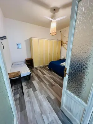 a room with a bedroom with a bed and a door at Covo del pescatore in Bagheria