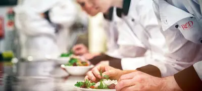 a group of chefs in a kitchen preparing food at Maya's Apartment close to Ballarò Market and Central station in Palermo