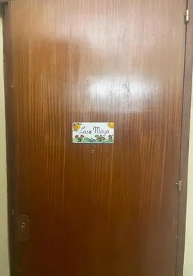 a brown door with a sign on it at Maya's Apartment close to Ballarò Market and Central station in Palermo