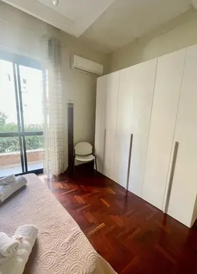 a bedroom with white cabinets and a wooden floor at Apartament Dimora di Maury a due passi dai trasporti e da Ballarò in Palermo