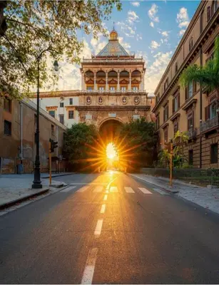 a building with a light at the end of a street at Hola Cathedral House Porta di Castro in Palermo