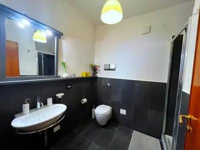 a small room with a bed and a bedroom with a window at Villa Mediterraneo in Altavilla Milicia