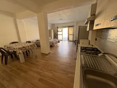 a kitchen and dining room with a table and a dining room at MC Rooms in Torretta