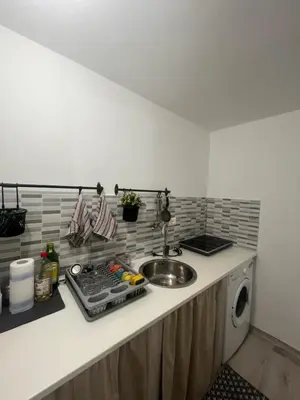 a kitchen counter with a sink and a washing machine at Casa chrilù in Palermo