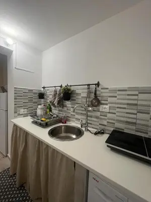 a kitchen counter with a sink in a kitchen at Casa chrilù in Palermo