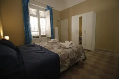 a bedroom with a bed with towels on it at Casa chrilù in Palermo