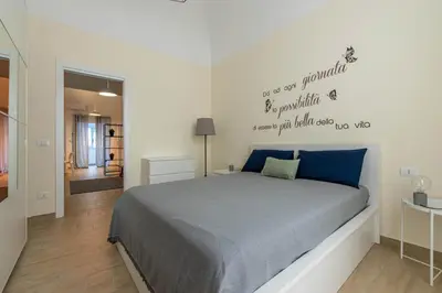 a bedroom with a large bed with blue sheets at Al Khalisa Apartment by Wonderful Italy in Palermo