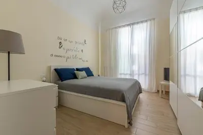 a bedroom with a bed with a writing on the wall at Al Khalisa Apartment by Wonderful Italy in Palermo
