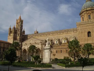 a large building with a clock tower and a cathedral at Al Khalisa Apartment by Wonderful Italy in Palermo