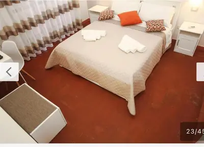 a bedroom with a large bed with two pillows on it at Villa San Vito Bay in Macari