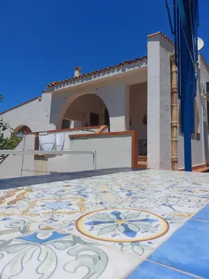 a villa with a tile floor in front of a house at Villa San Vito Bay in Macari