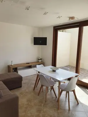 a living room with a white table and chairs at Dancing Apartment in Castelluzzo