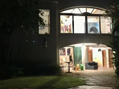a house with an archway in the dark at park house mini in Mondello