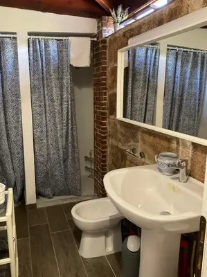 a bathroom with a white sink and a toilet at la Casetta di Laura in Terrasini