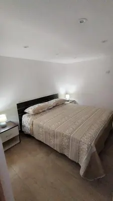 a bedroom with a large bed and two night stands at Casa Vacanze da Peppe in Palermo