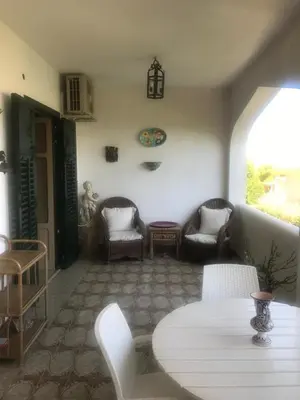 a living room with a table and chairs at Casa Delizia in Lido di Mondello