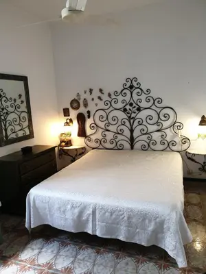 a bedroom with a large bed with a white bedspread at Casa Delizia in Lido di Mondello