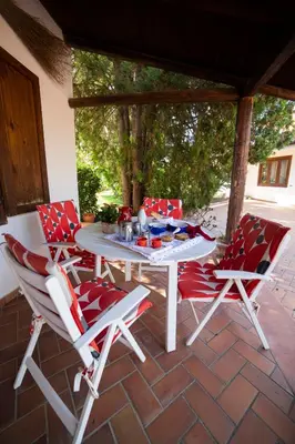 a white table and four chairs on a patio at Le Yucche in Partinico