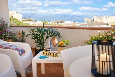 a balcony with a table and chairs and a view at Limoncello Apri la finestra e respira il profumo del mare Alloggio Spazioso in Sicilia Comfort per 6 Ospiti in Castellammare del Golfo