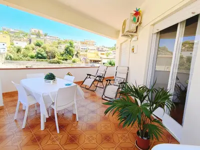 a balcony with a table and chairs and a view at Limoncello Apri la finestra e respira il profumo del mare Alloggio Spazioso in Sicilia Comfort per 6 Ospiti in Castellammare del Golfo