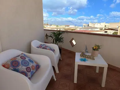 a balcony with a table and chairs and a view at Limoncello Apri la finestra e respira il profumo del mare Alloggio Spazioso in Sicilia Comfort per 6 Ospiti in Castellammare del Golfo