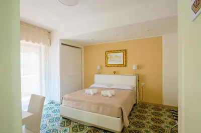 a bedroom with a bed with two towels on it at Le Stanze dei Tesori - Luxury Rooms in Palermo