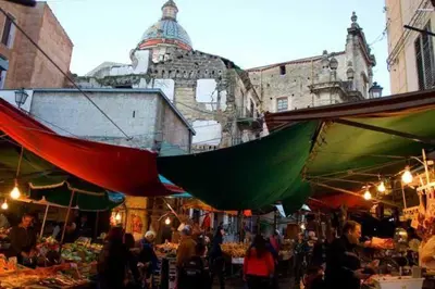 a group of people walking around a market with umbrellas at Casamaqueda26, Bilocale indipendente presso palazzo Filangeri-Cutò in Palermo