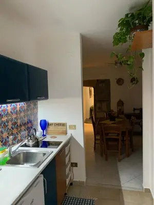 a kitchen with a sink and a kitchen with a table at La Giara in Palermo